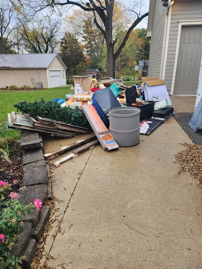 Dumpster being loaded with debris for Commercial Dumpster Rental in Handy